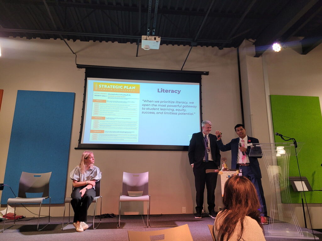 student on stage with school executives