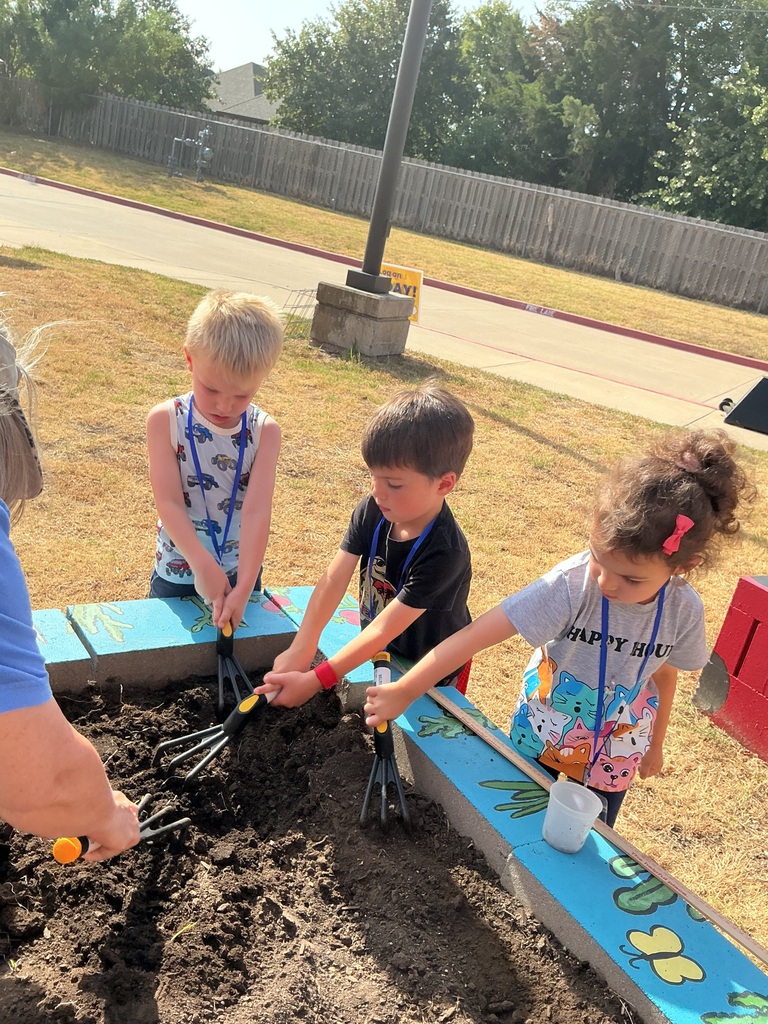 Students digging in dirt.