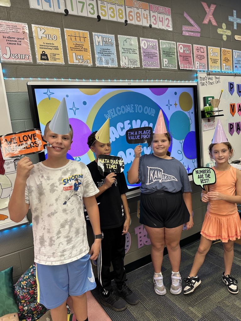 kids holding signs about math