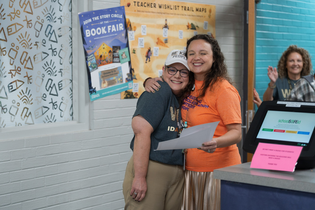 core value award winner being surprised at their school, hugging administrator