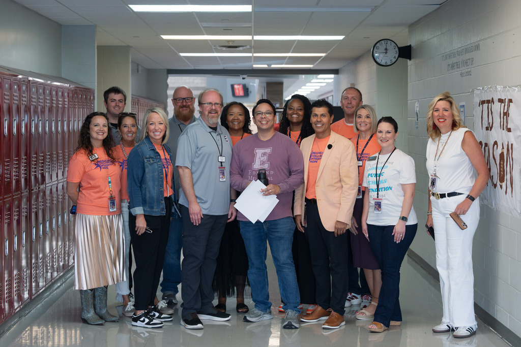 core value award recipient standing with administrators and holding their award