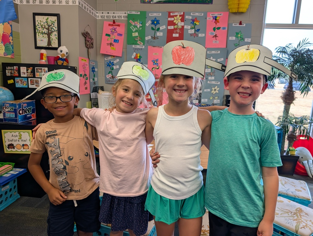 children posing with their art 