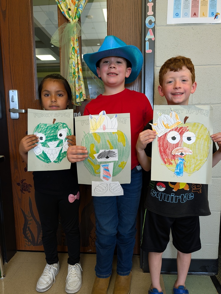 children posing with their art 