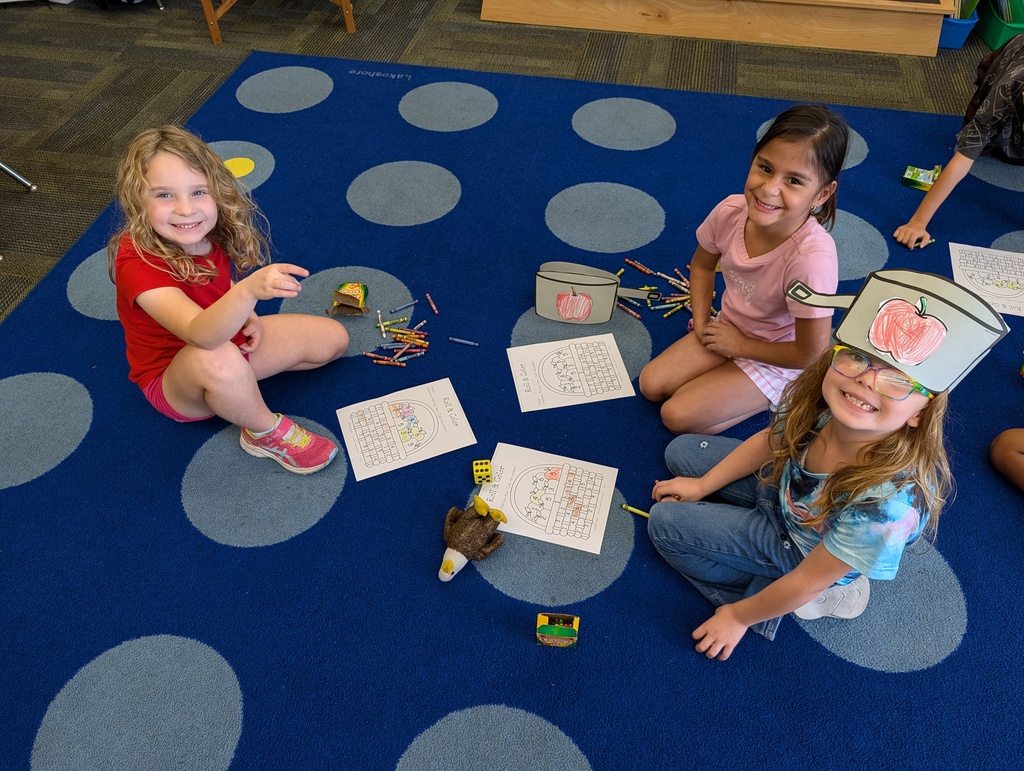children posing with their art 
