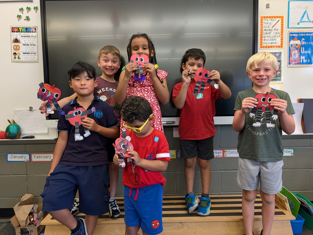 children posing with their art 
