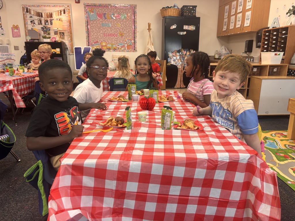Students tasting apples and applesauce for Johnny Appleseed Day. 