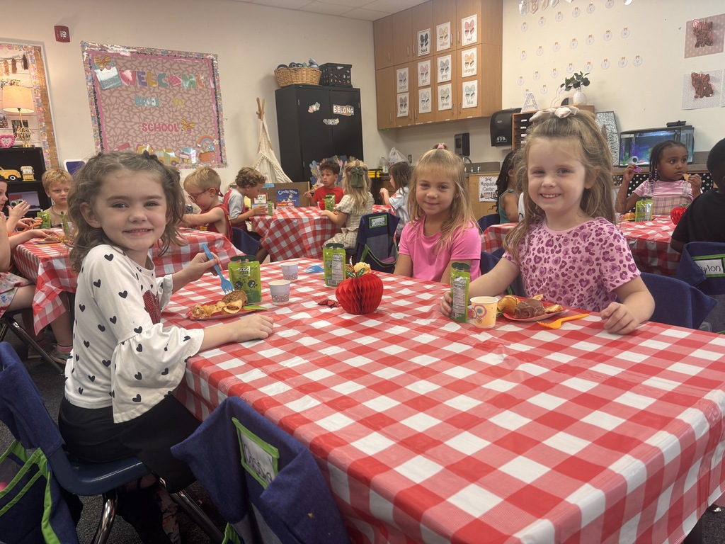 Students tasting apples and applesauce for Johnny Appleseed Day. 