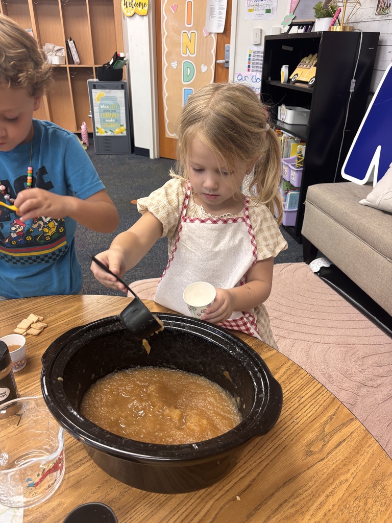 Students tasting apples and applesauce for Johnny Appleseed Day. 