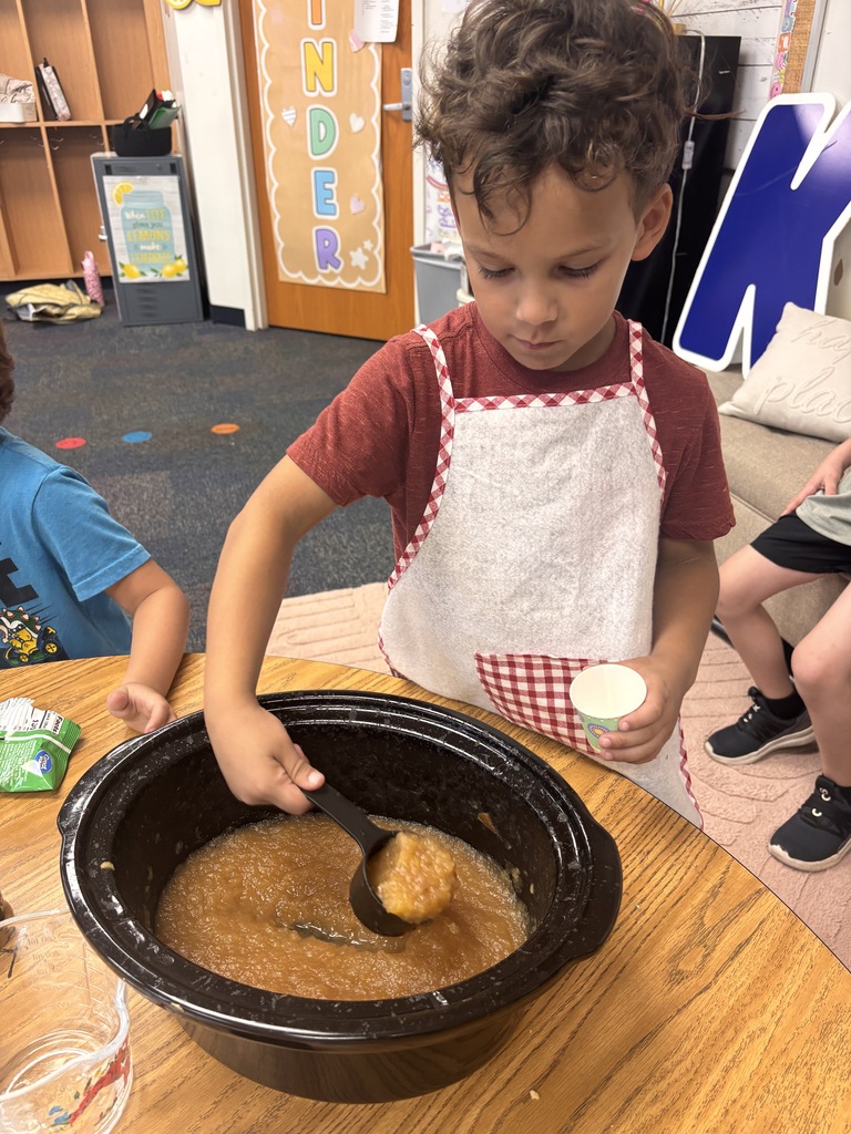 Students tasting apples and applesauce for Johnny Appleseed Day. 