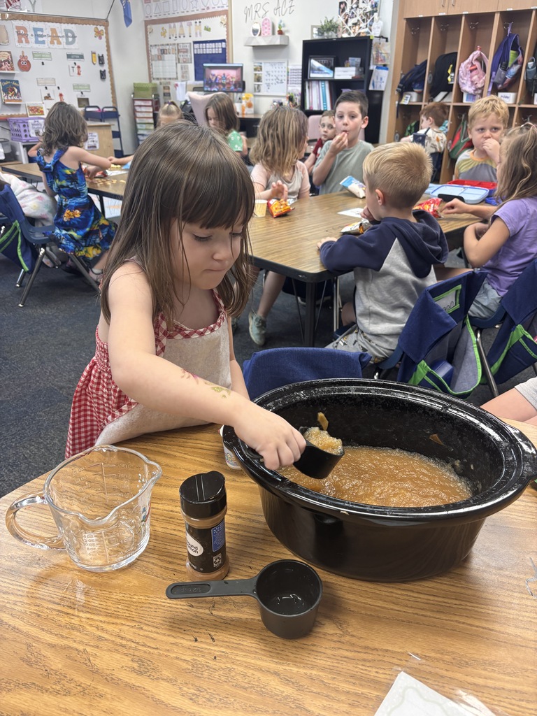 Students tasting apples and applesauce for Johnny Appleseed Day. 