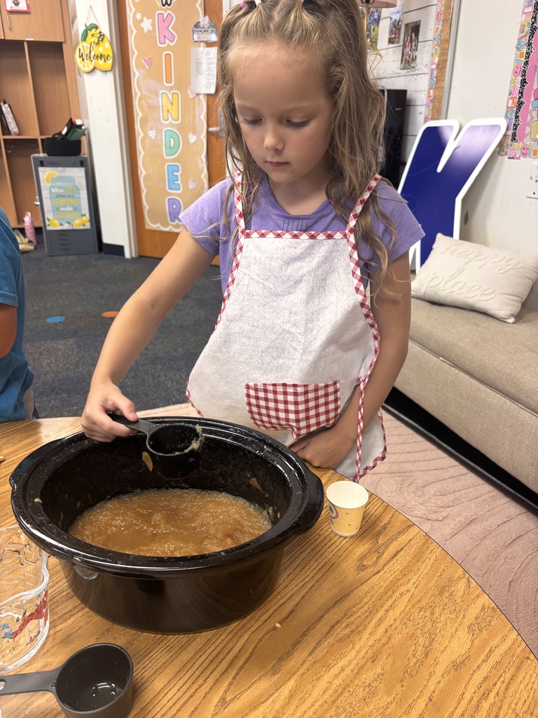 Students tasting apples and applesauce for Johnny Appleseed Day. 