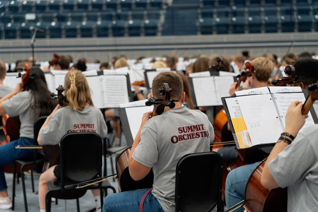 middle school student playing instrument in large band room