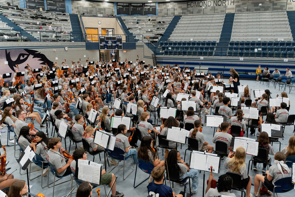 middle school student playing instrument in large band room