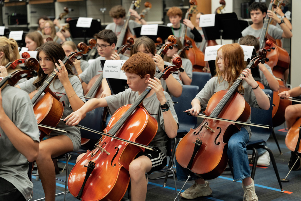 middle school student playing instrument in large band room