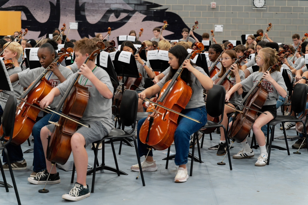 middle school student playing instrument in large band room
