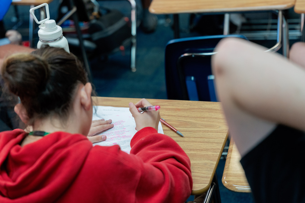 student writing on paper