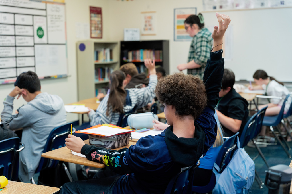 student raising hands