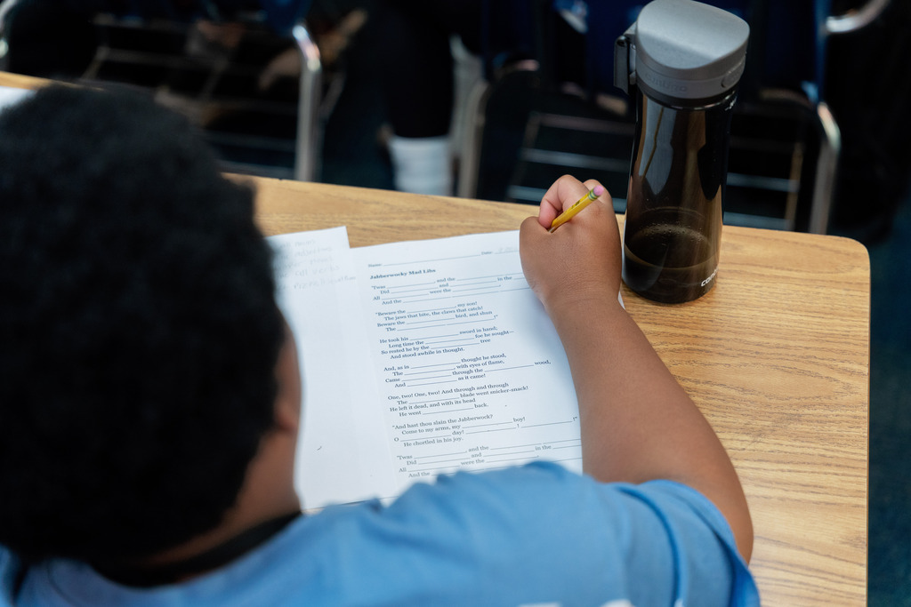student writing on paper