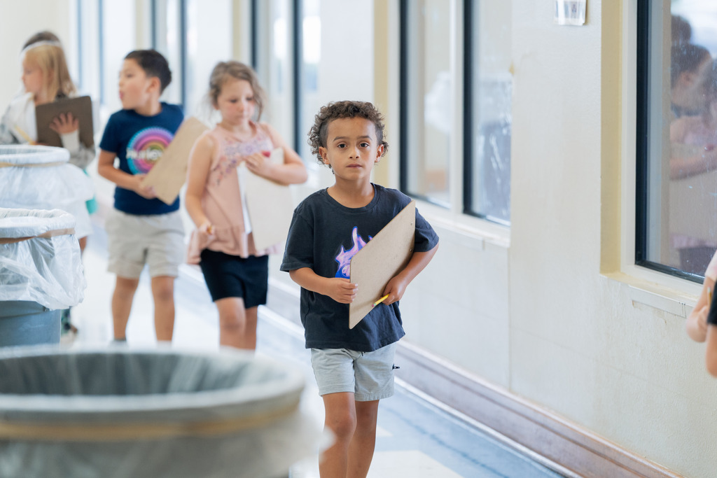 student walking with a clipboard