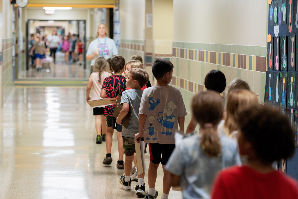 students walking in a line down the hall
