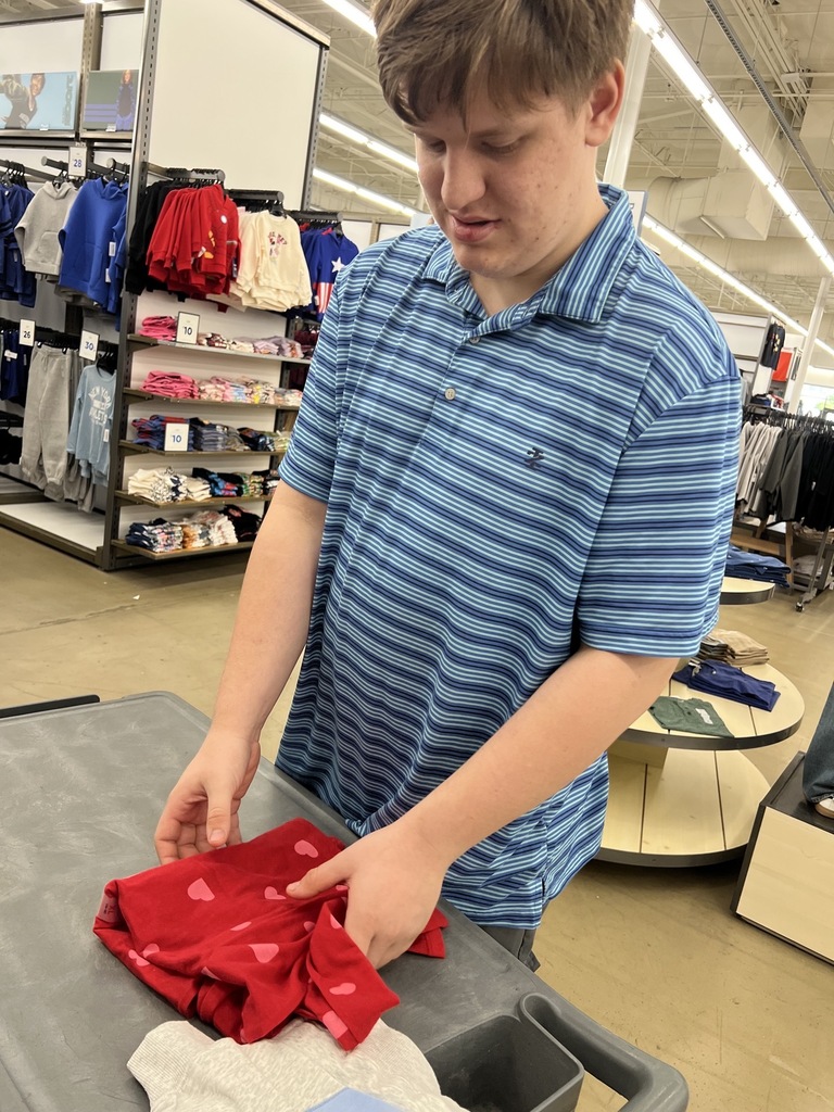 Intern folding clothes at Old Navy