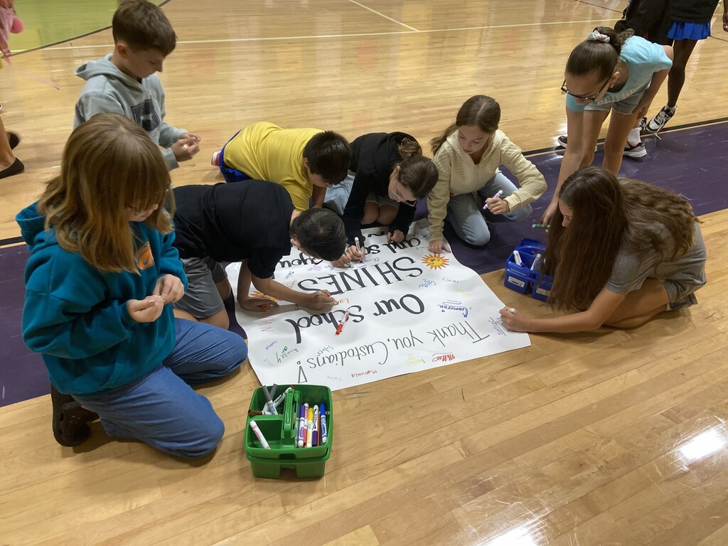 students signing appreciation poster