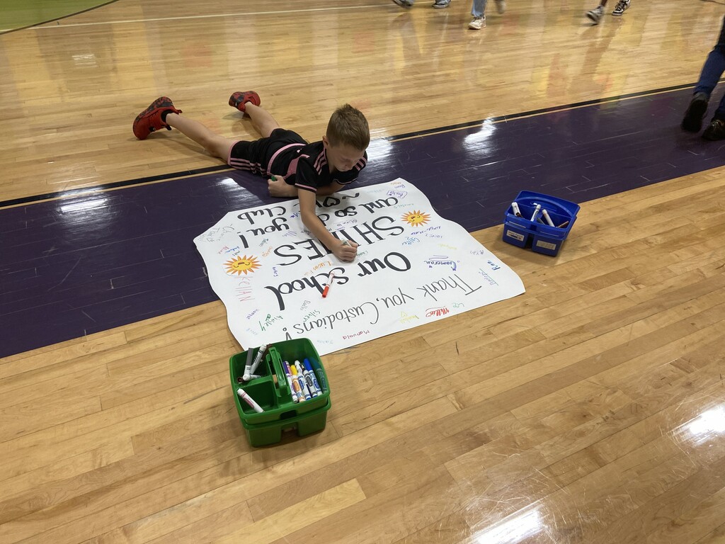students signing appreciation poster