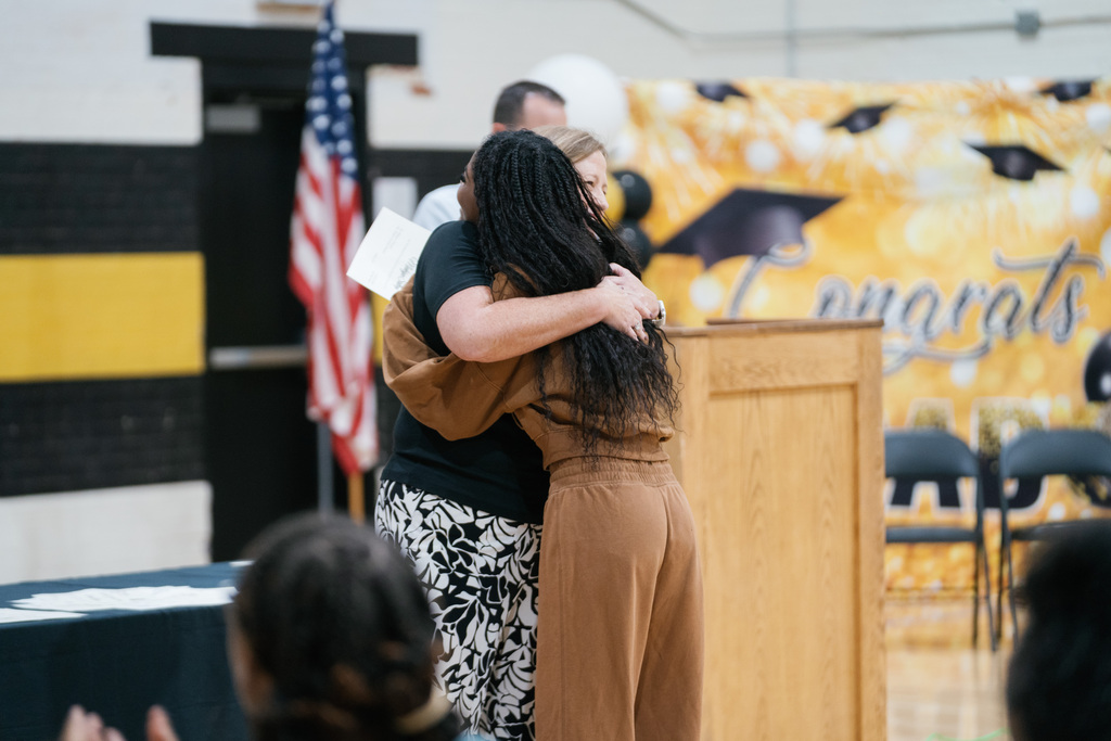 Student hugging a teacher