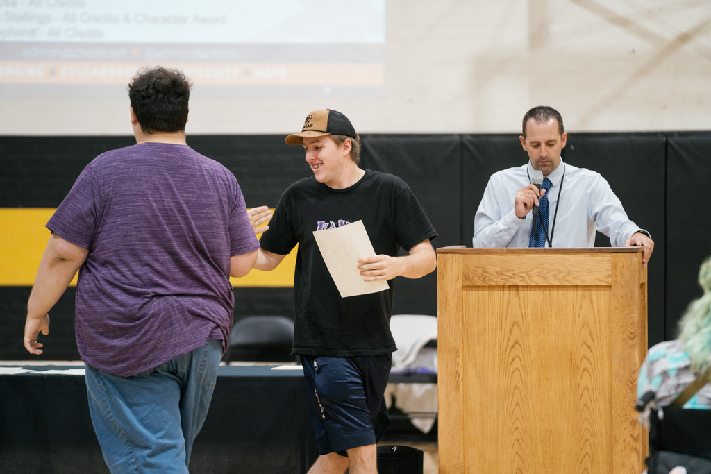 Students high fiving during award ceremony