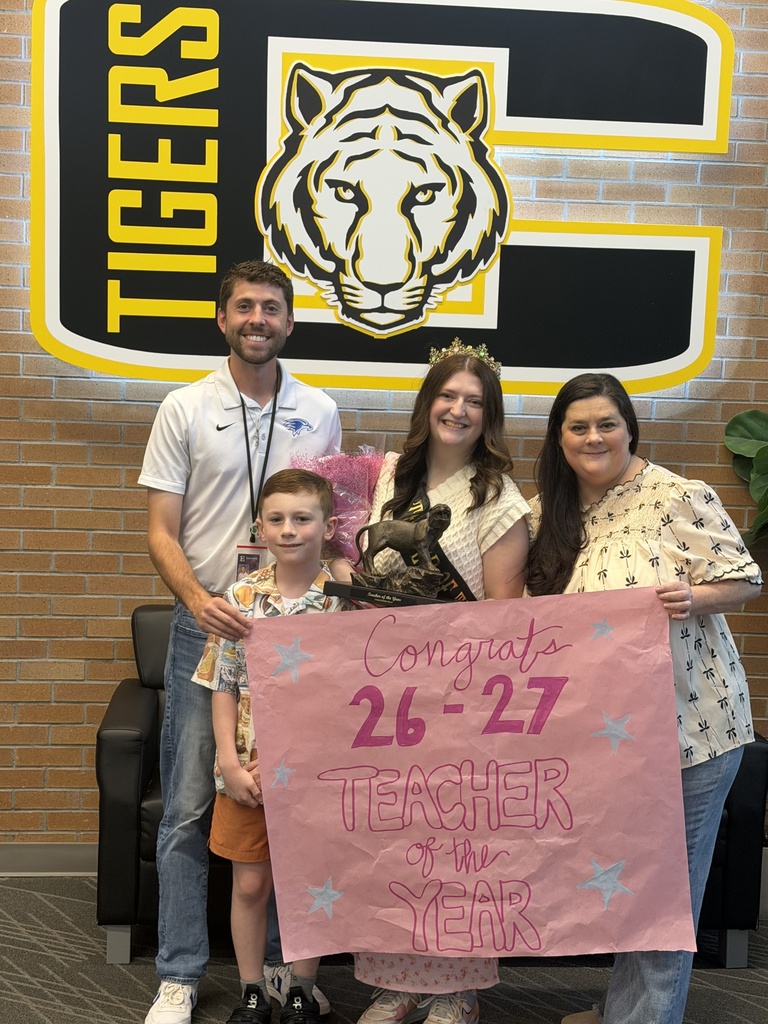 entral Middle School Teacher of the Year Mrs. Cheyenne DeWindt smiling for a photo with her family.