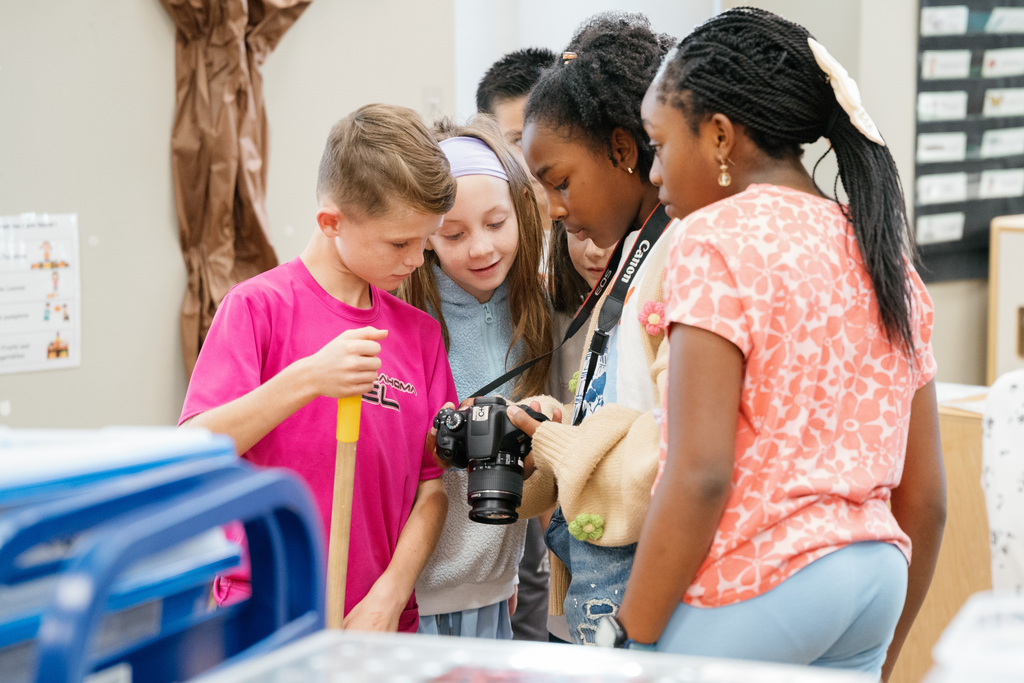 instructor showing camera to students