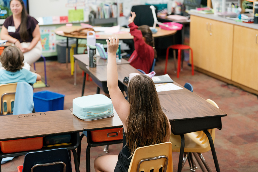 student raising her hand