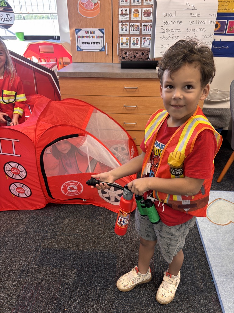 Kinder students dressed up as community helpers like firefighters, vets, and doctors. 