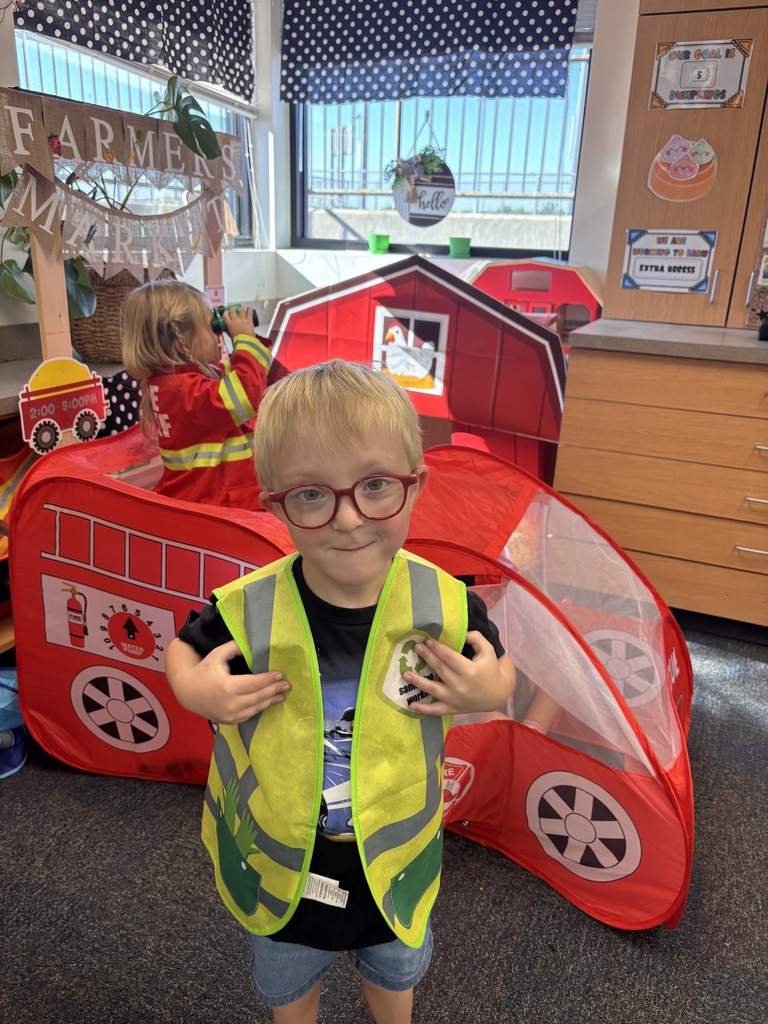 Kinder students dressed up as community helpers like firefighters, vets, and doctors. 