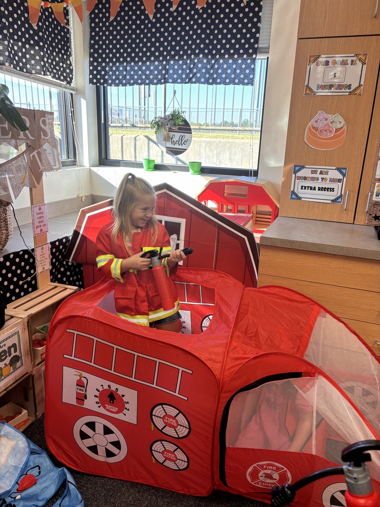 Kinder students dressed up as community helpers like firefighters, vets, and doctors. 