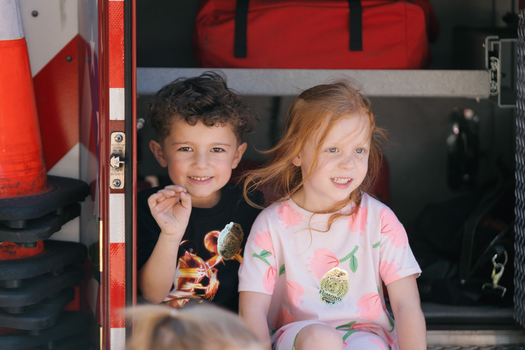students in a fire truck smiling