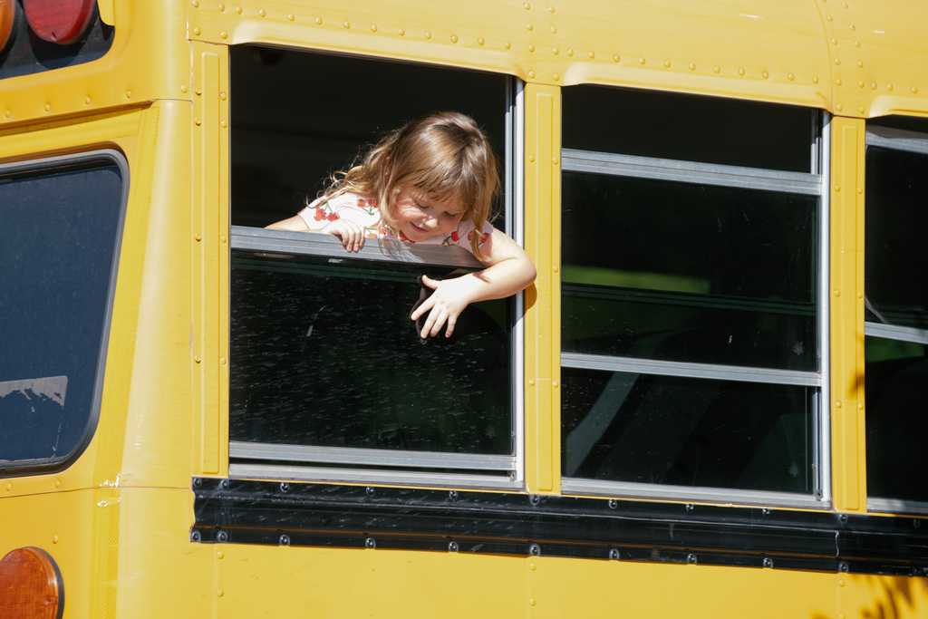 student looking out of a bus window