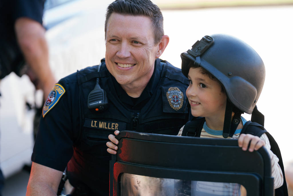 police officer and student smiling