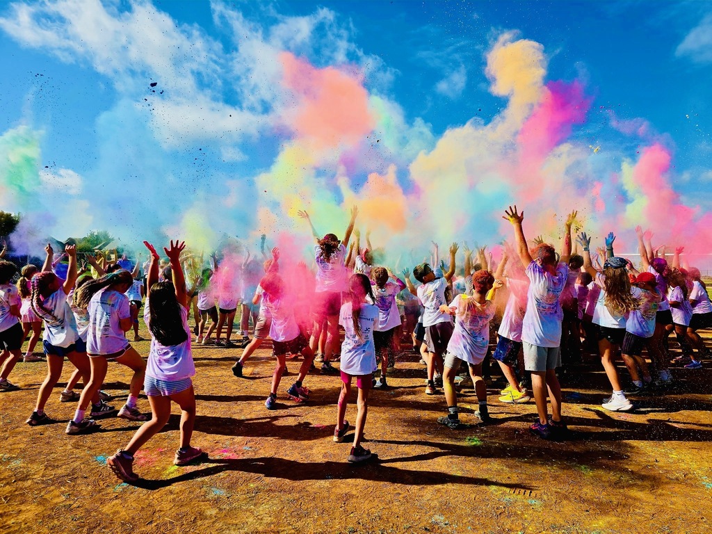 students with color powder throwing it in the air