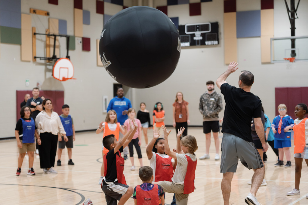 parent playing in pe with students