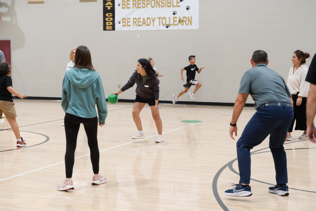 parent playing in pe with students