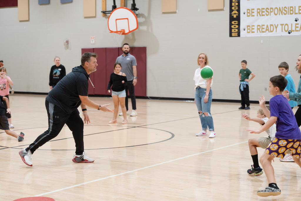 parent playing in pe with students