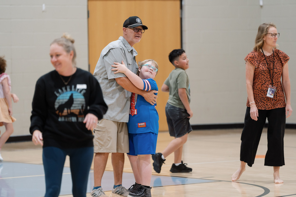 parent playing in pe with students
