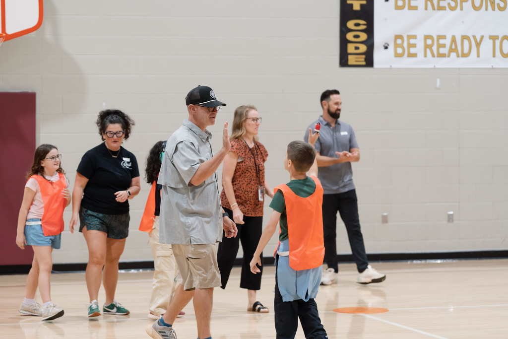 parent playing in pe with students