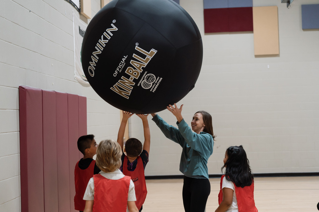 parent playing in pe with students