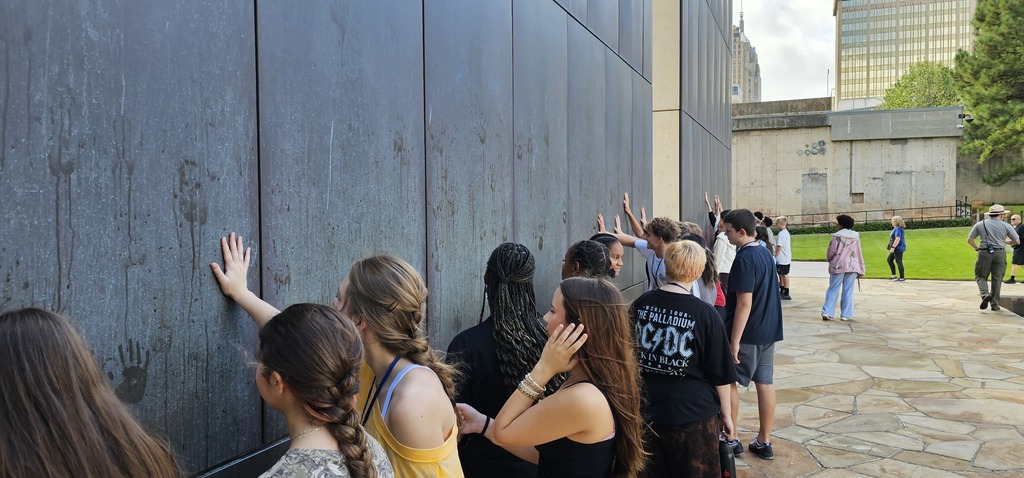 Students leaving wet hand prints on the Gates of Time.