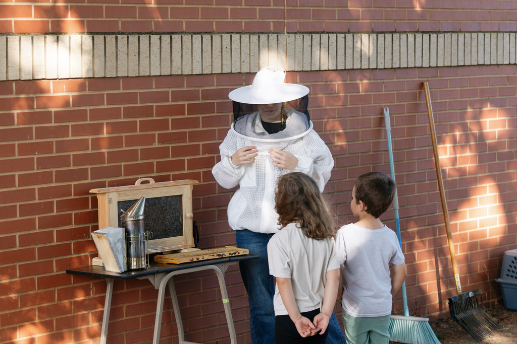 beekeeper teaching young students
