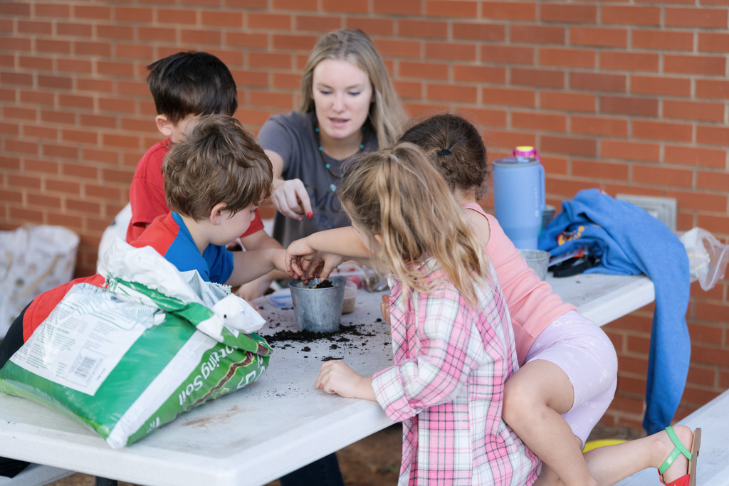 students playing with dirt