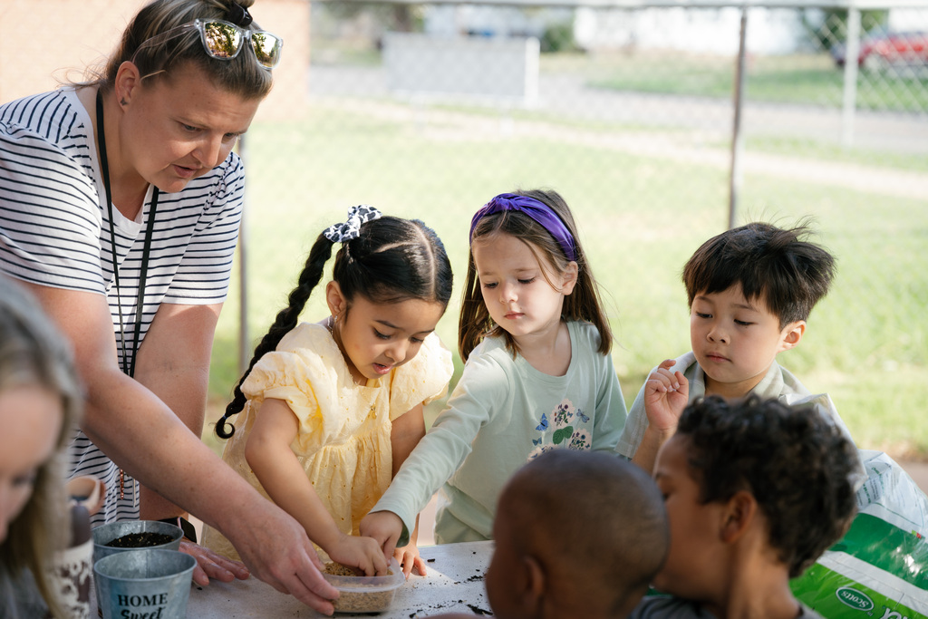 students playing with dirt