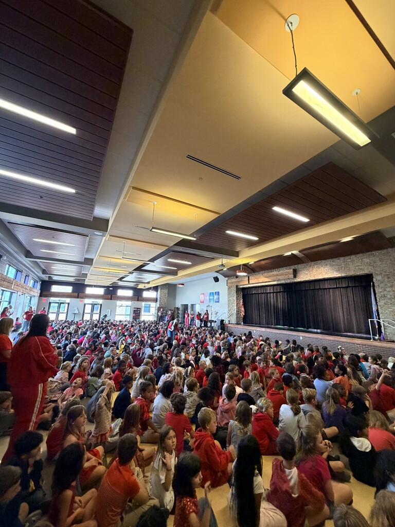 students wearing red for Red Ribbon Week waiting for the fir safety skit to begin